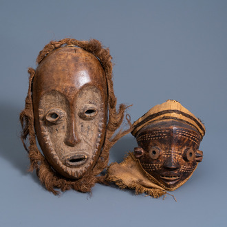 A carved wooden 'idimu' mask and a 'mbuya' mask, Lega and Pende, Congo, 20th C.