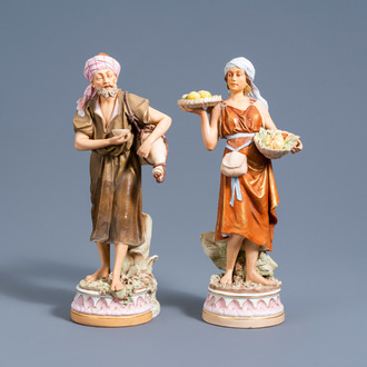 A pair of polychrome decorated biscuit oriental figures with a water bag and fruit baskets, Royal Dux, 20th C.