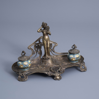 A brass Art Nouveau style ink well with floral design and a lady looking in the mirror, 20th C.