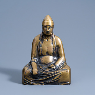 A Tibetan bronze figure of a lama, 20th C.