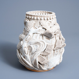 A Chinese monochrome white Nanking vase with landscape relief design, 19th C.
