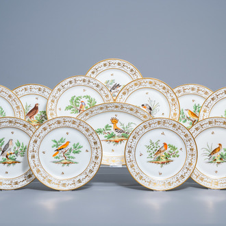 A set of eleven French plates and one oval charger with gilt and polychrome exotic birds design, 19th C.