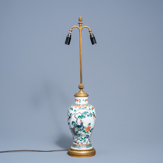 A Chinese famille verte vase with birds among blossoming branches mounted as a lamp, 19th C.
