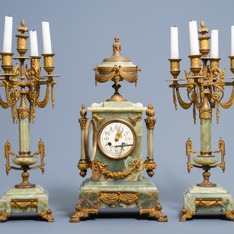 A French Louis XVI style gilt bronze mounted green onyx three-piece clock garniture, first half of the 20th C.