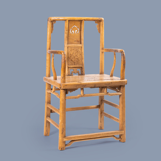 A Chinese elmwood chair with carved and reticulated panels, 19th/20th C.