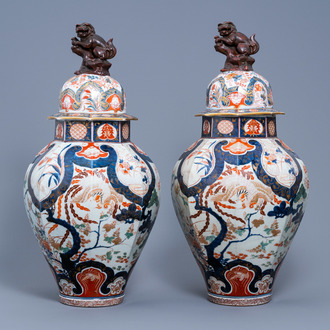 A pair of large Japanese Imari vases and covers with a phoenix among blossoming branches, Edo, 18th C.