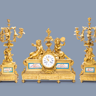 A French gilt bronze three-piece clock garniture with musicians and Sèvres style plaques, 19th C.