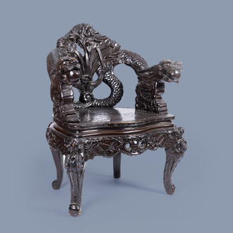 A Japanese carved wood 'dragons and irises' chair, 19th/20th C.