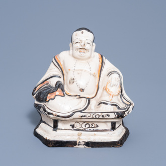 A Chinese Cizhou glazed figure of the laughing Buddha or Budai, probably Ming