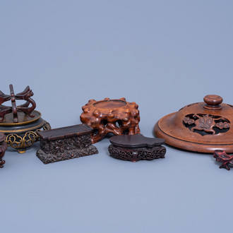 A collection of Chinese carved wood and bronze stands and a reticulated wood cover, 19th/20th C.