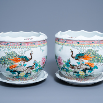 A pair of Chinese famille rose jardinières on stand with peacocks among blossoming branches, 20th C.