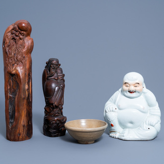 A Chinese white, iron red and gilt porcelain figure of Buddha, two carved wood figures and a celadon bowl, 19th/20th C.
