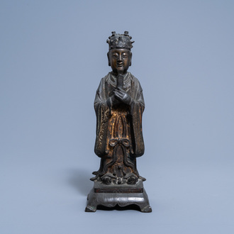 A Chinese partly gilt and lacquered bronze figure of a dignitary, Ming