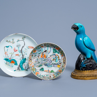Two Chinese famille rose and verte plates and a turquoise and aubergine glazed parrot, 19th C.