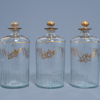 Three French cut glass flasks and covers with gilt floral design, 18th C.