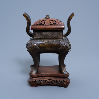 A Chinese gilt bronze censer with wood cover and stand, Qing