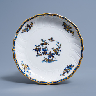 A Tournai porcelain blue, white and gilt plate with 'Ronda à la mouche' design and a gilt sword mark, 18th C.