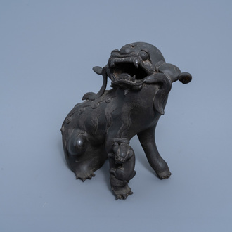 A Chinese bronze model of a Buddhist lion with cub, Qing