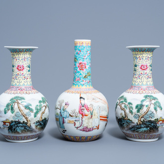 A pair of Chinese bottle shaped famille rose vases with an animated landscape and a vase with figurative design, 20th C.