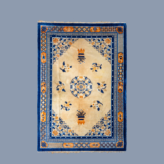 A Chinese woolen 'Beijing' rug with floral design, ca. 1900