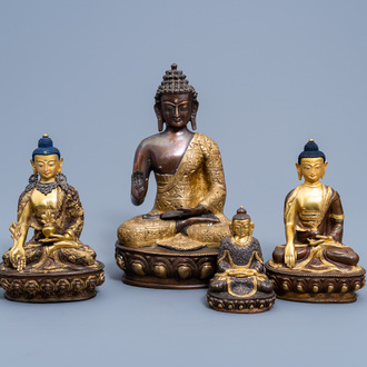 Four Sino-Tibetan partly gilt bronze figures of Buddha, 20th C.