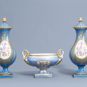 A pair of French gold layered 'bleu celeste' ground vases and covers in the Sèvres manner and an Empire style centrepiece, 19th/20th C.