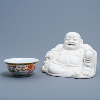 A Chinese famille rose 'dragon and phoenix' bowl and a blanc de Chine figure of Buddha, Republic, 20th C.