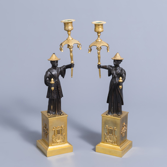 An extraordinary pair of French Empire style patinated bronze and ormolu chinoiserie candelabra, early 19th C.