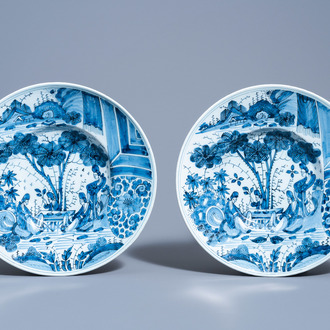 A pair of Dutch Delft blue and white chinoiserie chargers by Gerrit Kam, ca. 1700