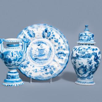A Dutch Delft blue and white gadrooned dish with a boat and two vases with figures in a garden, 17th/18th C.