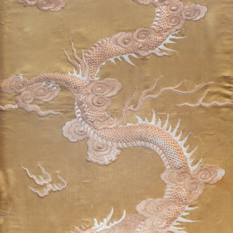 A Chinese vertical silk embroidery with a dragon chasing the pearl, 19th C.