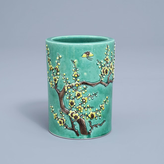 A Chinese green ground brush pot with floral relief design, Republic, 20th C.