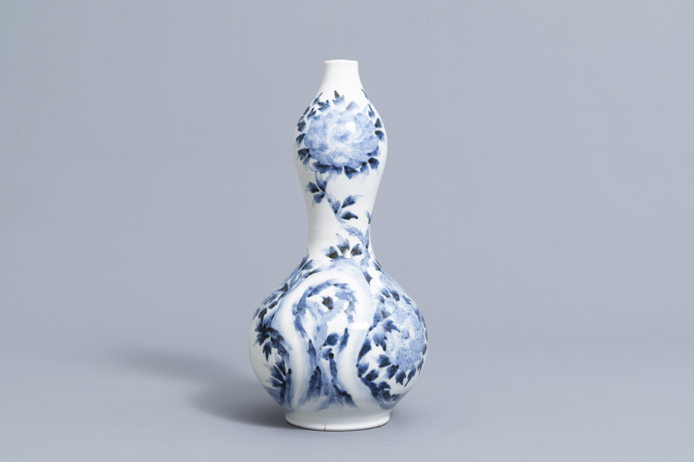 A Japanese blue and white Arita double gourd vase with birds among blossoming branches all around, Meiji, ca. 1900