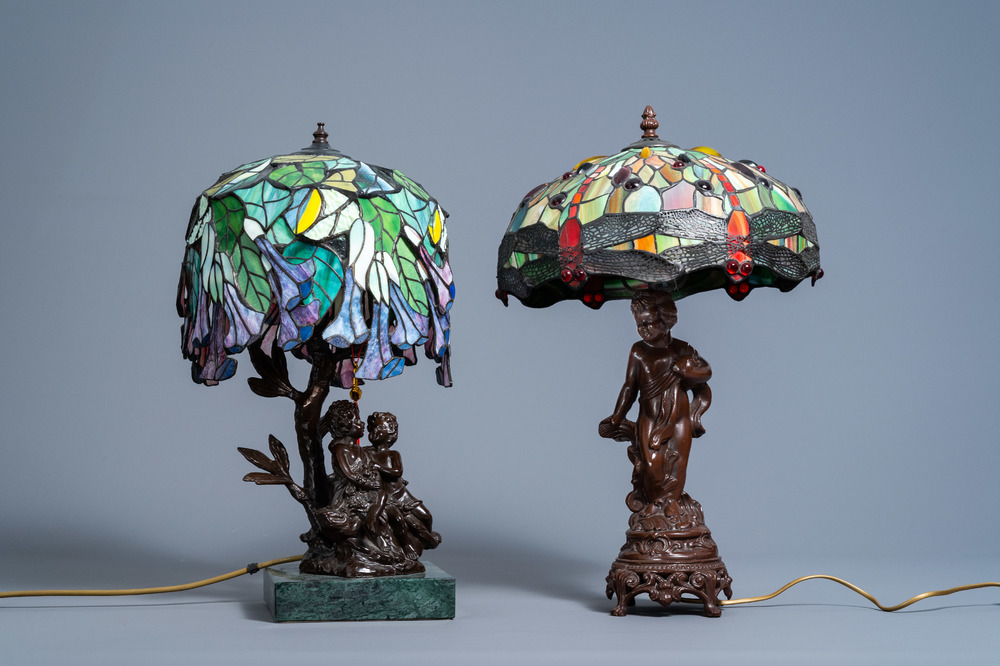 Two Tiffany style 'dragonfly' and 'flower' lamps with glass shades, 20th C.