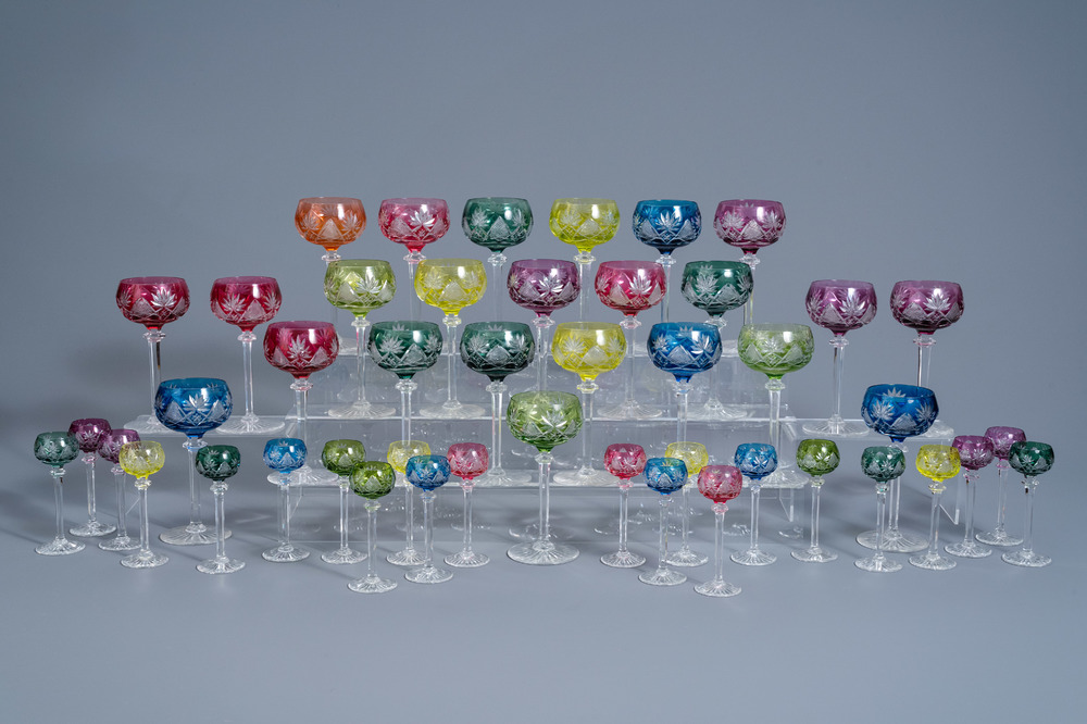 An extensive collection of partly coloured overlay crystal cut glasses, 20th C.